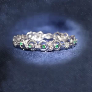 round emeralds and diamonds in a decorative link bracelet
