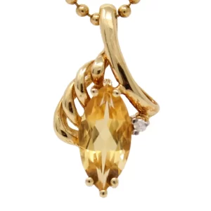 marquise citrine pendant in swirls of 14K yellow gold accented with one small round diamond