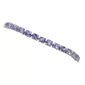 round blue gemstones prong set in a line bracelet
