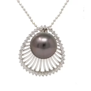 black pearl set on a claim shell edged with diamonds