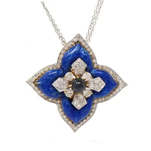blue enamel flower pendant has one center cabochon sapphire surrounded by diamond petals surrounded by blue enamel surrounded by diamonds
