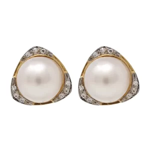 omega back earrings with a large mabe pearl and accent diamonds in a yellow gold triangular setting