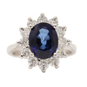 white gold ring with an oval sapphire and a halo of round diamonds