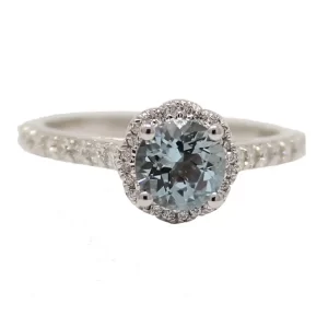 round aquamarine surrounded by diamond in a scalloped halo and with diamonds accented the shoulders