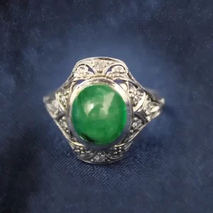 cabochon emerald with a high dome in an art deco setting.