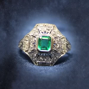 step-cut emerald in an art deco setting accented with mixed-cut small diamonds