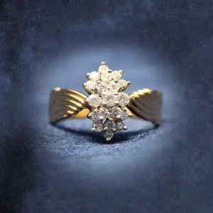 cluster of round diamonds with chevron shoulders on the band; ring resembles an angel with wings