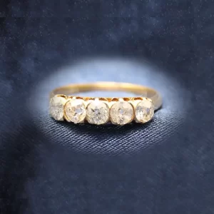 5 round diamonds bezel set east-west in an gold band