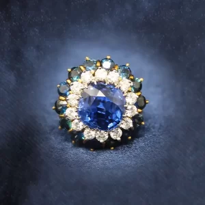 cushion-cut center sapphire surrounded by a round diamond halo surrounded by a round sapphire halo