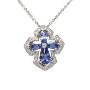 white gold cross pendant with 4 various shape blue sapphires outlined with 36 individually-set round diamonds