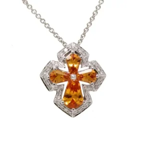 white gold cross pendant with 4 various shape blue sapphires outlined with 36 individually-set round diamonds